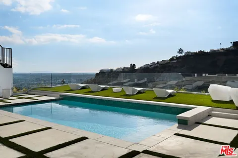 an aerial view of a house with a swimming pool