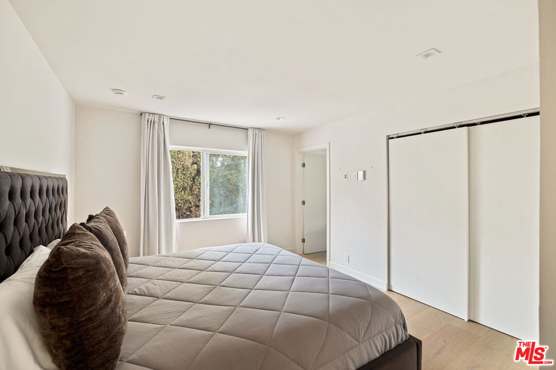 7868 Electra Drive Los Angeles, CA 90046 - Photo 31 of 42 a bedroom with a bed and a window