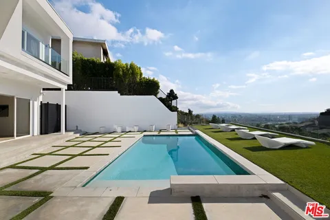 a view of a pool in the backyard of house