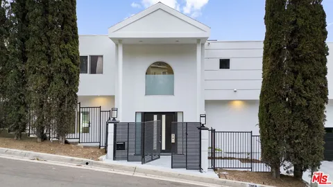 a front view of a building with parking