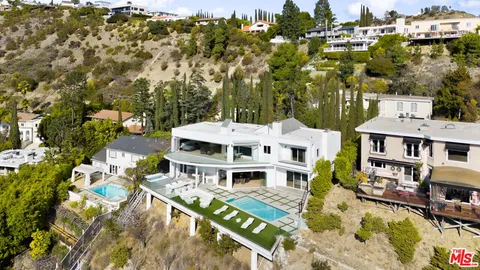 a view of a house with a large trees
