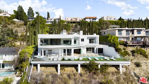 a balcony with tall buildings and a yard