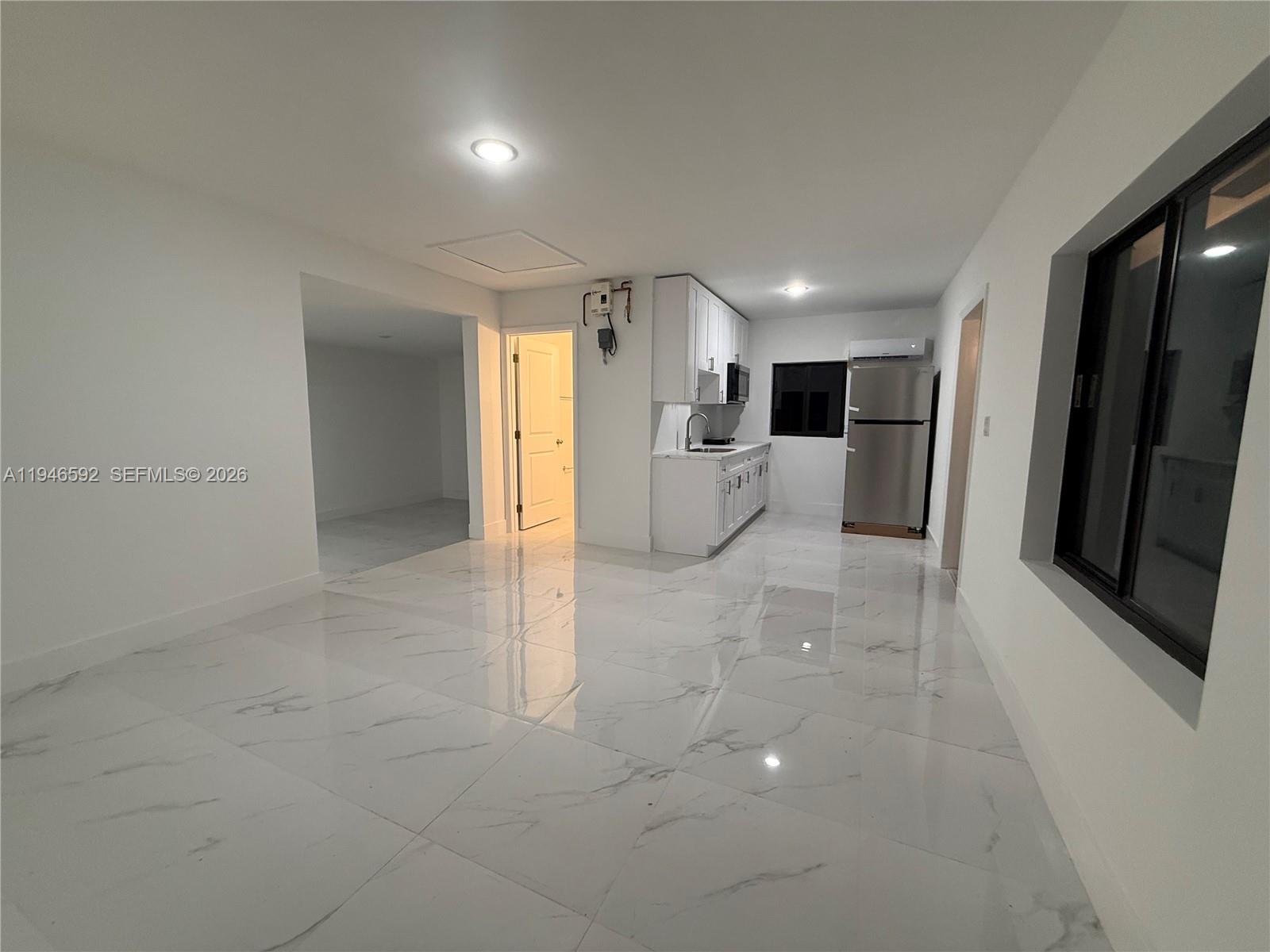 450 Beacom Boulevard, Unit C Miami, FL 33135 - Photo 4 of 9 a view of a hallway with a kitchen