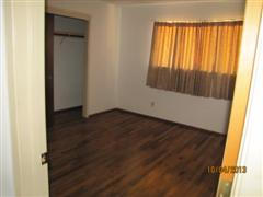 2663 Irwin Road Redding, CA 96002 - Photo 3 of 8 an empty room with wooden floor and windows