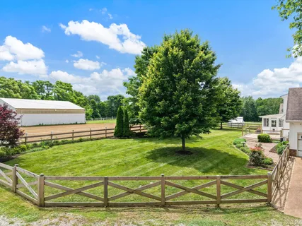 a swimming pool with outdoor seating and garden