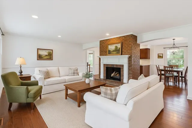 a living room with wooden floors and a fireplace
