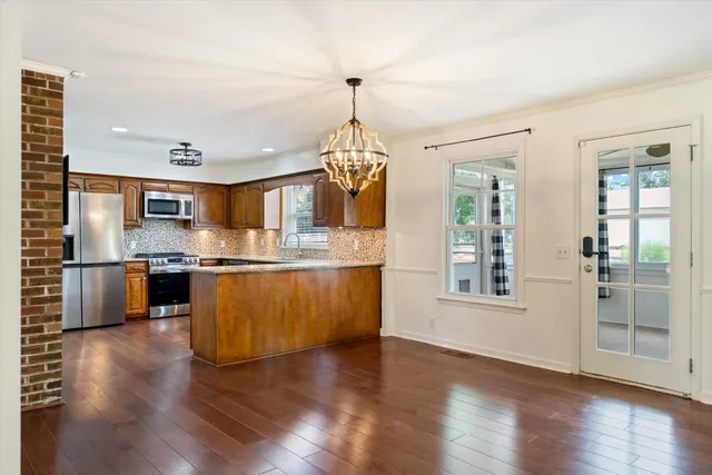 a dining room with furniture and wooden floor
