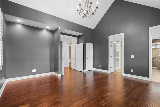 a bedroom with a bed and a dresser next to a window