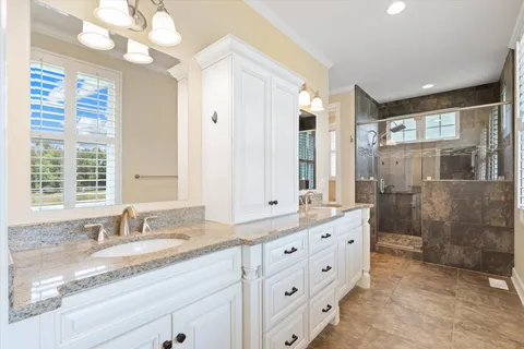 a bathroom with a double vanity sink and a mirror