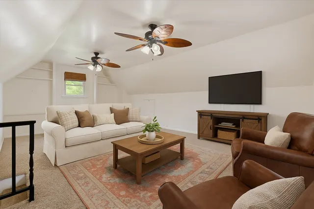an empty room with wooden floor ceiling fan and windows