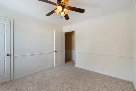 a bathroom with a granite countertop sink a toilet and a mirror