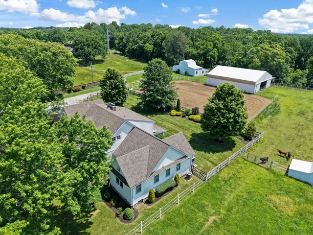 an aerial view of a house with yard swimming pool and outdoor seating