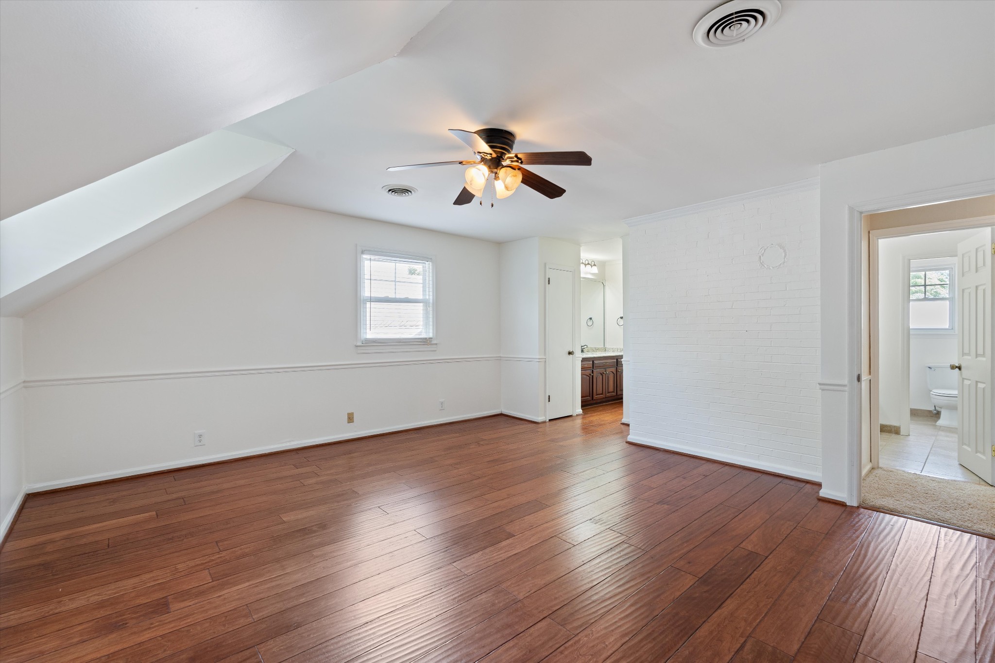 1967 Liebengood Road Goodlettsville, TN 37072 - Photo 52 of 57 an empty room with wooden floor ceiling fan and windows