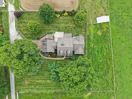 an aerial view of a house with a yard