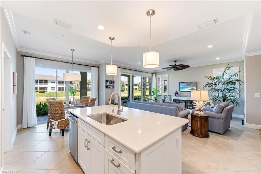 6948 Avalon Circle, Unit 604 Naples, FL 34112 - Photo 13 of 33 Kitchen featuring a sink, visible vents, a ceiling fan, and crown molding