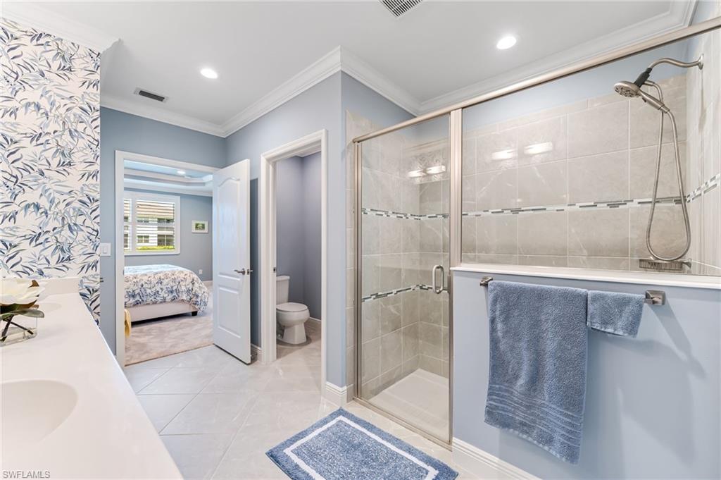 6948 Avalon Circle, Unit 604 Naples, FL 34112 - Photo 19 of 33 Ensuite bathroom with crown molding, a shower stall, visible vents, recessed lighting, and toilet