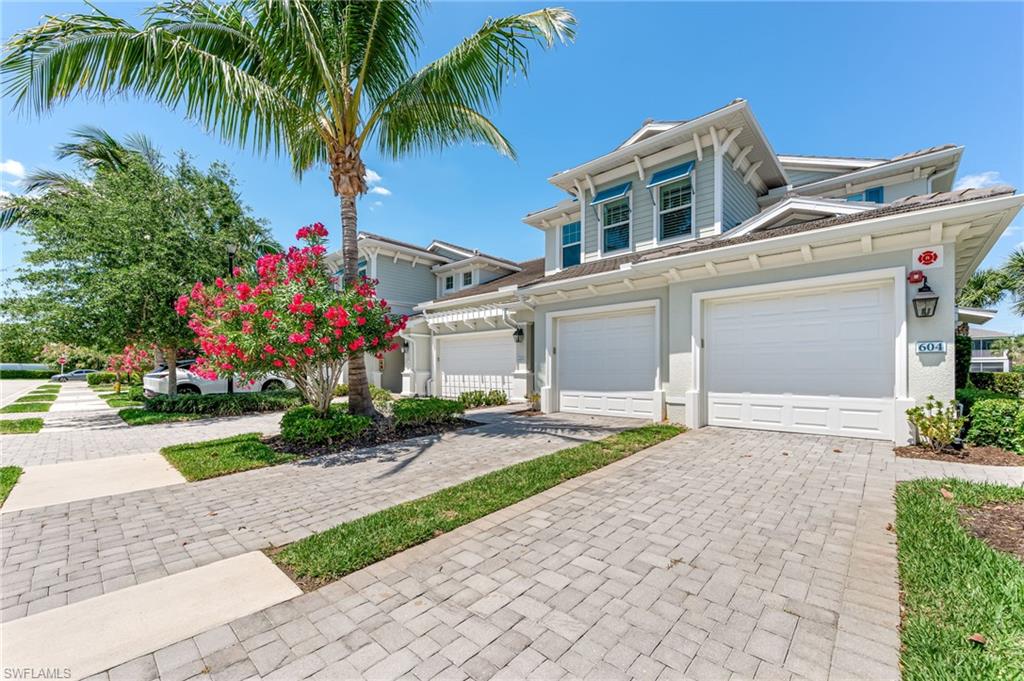 6948 Avalon Circle, Unit 604 Naples, FL 34112 - Photo 2 of 33 View of front of home with a garage and driveway