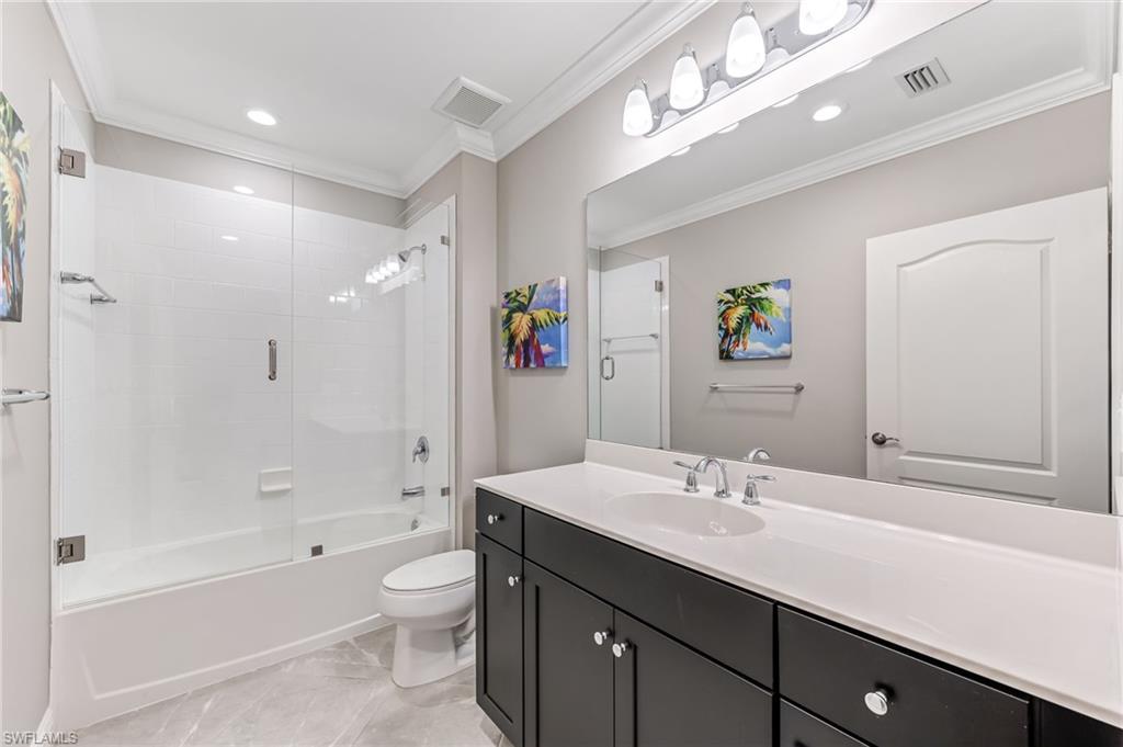 6948 Avalon Circle, Unit 604 Naples, FL 34112 - Photo 22 of 33 Full bathroom featuring toilet, crown molding, vanity, and visible vents