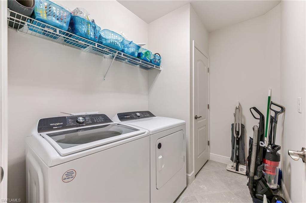 6948 Avalon Circle, Unit 604 Naples, FL 34112 - Photo 23 of 33 Laundry area featuring separate washer and dryer, laundry area, and baseboards