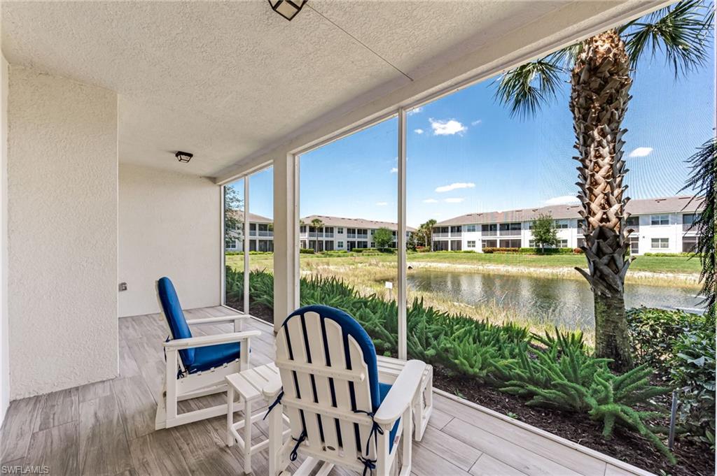 6948 Avalon Circle, Unit 604 Naples, FL 34112 - Photo 25 of 33 Sunroom with a water view and a residential view