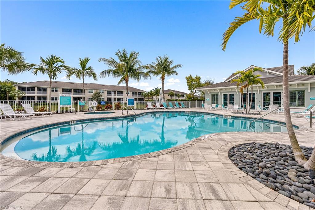 6948 Avalon Circle, Unit 604 Naples, FL 34112 - Photo 30 of 33 Community pool with a patio area and fence
