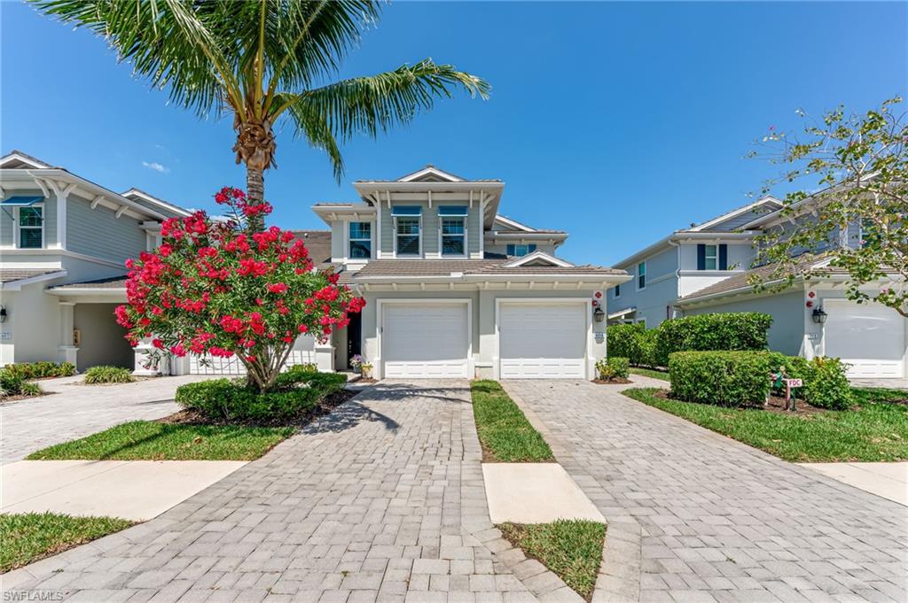 6948 Avalon Circle, Unit 604 Naples, FL 34112 - Photo 3 of 33 Traditional-style house featuring a garage, decorative driveway, and stucco siding
