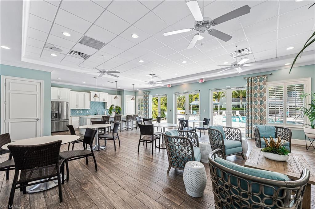 6948 Avalon Circle, Unit 604 Naples, FL 34112 - Photo 31 of 33 Dining room with visible vents, ceiling fan, a drop ceiling, and wood finished floors
