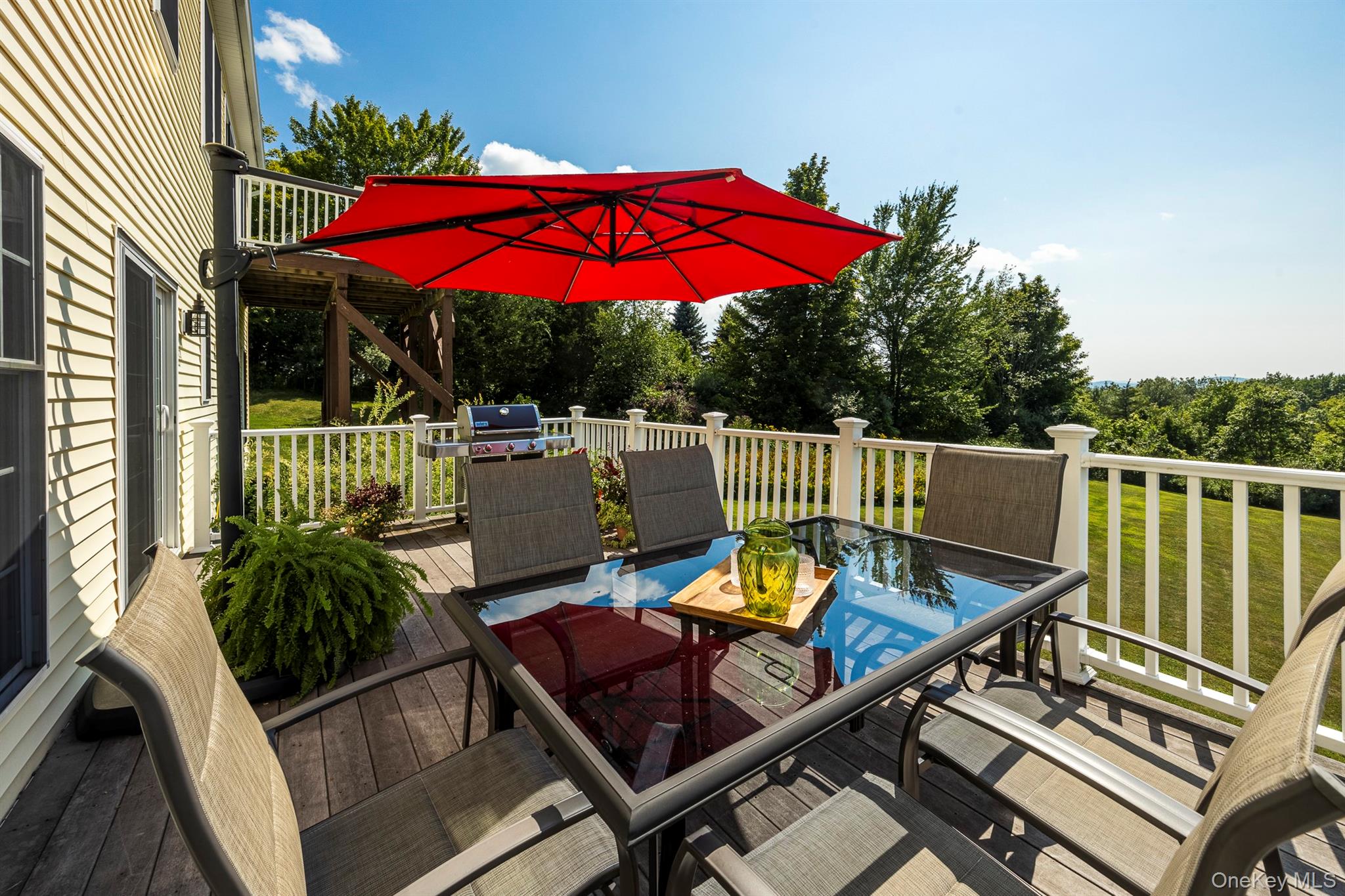 74 Willow Brook Ridge Clinton Corners, NY 12514 - Photo 18 of 44 The deck runs along the family room and eat in kitchen.