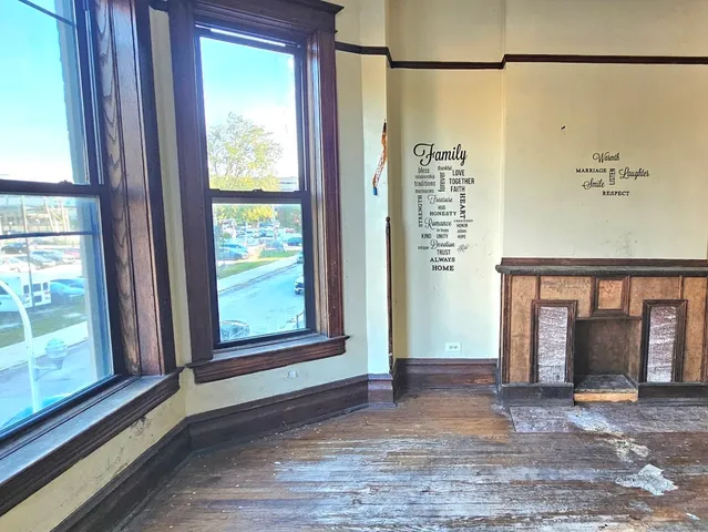 a view of a room with a window and front door
