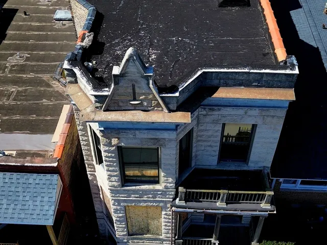 an aerial view of a house with a yard