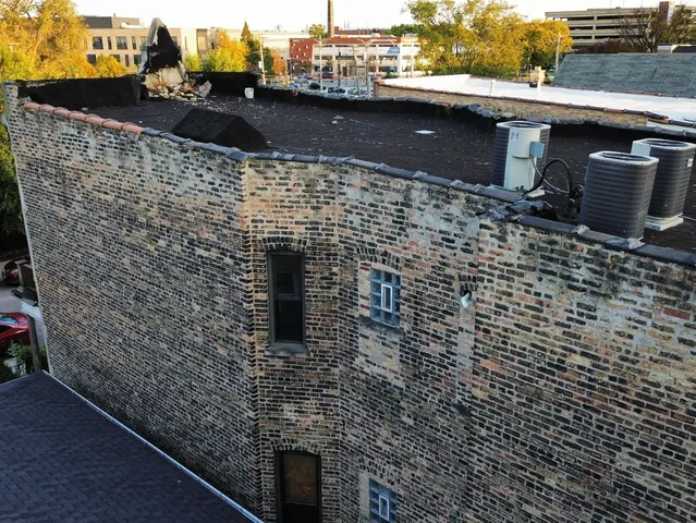 a view of a room with a window and wooden floor