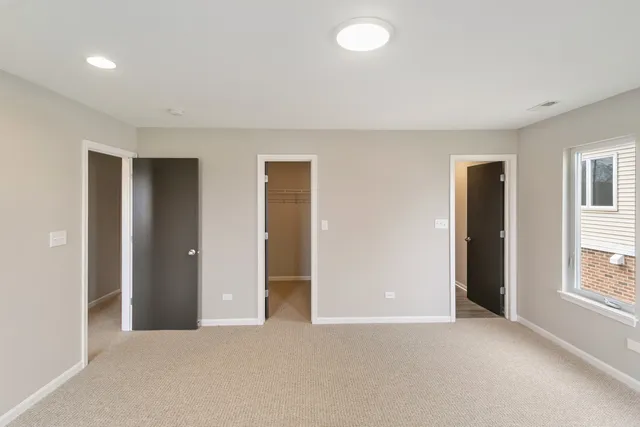 an empty room with windows and closet