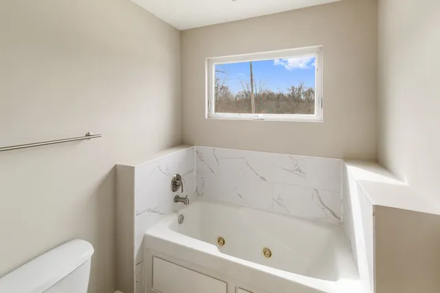 a view of an empty room with wooden walls