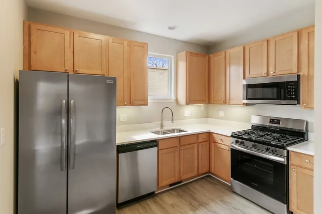 a kitchen with stainless steel appliances granite countertop a refrigerator sink and cabinets