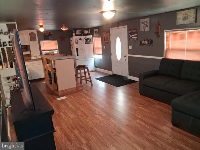 a view of a living room with furniture and a flat screen tv