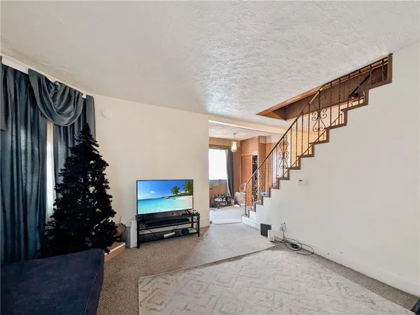 a room with stairs and a flower pot