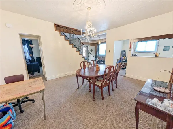 a dining room with furniture a chandelier and wooden floor