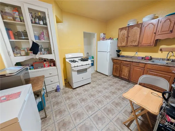 a kitchen with stainless steel appliances a stove a refrigerator and a wooden cabinets