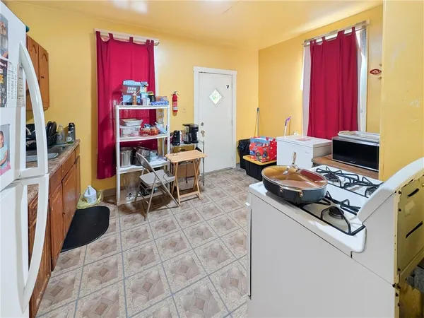 a living room with furniture a red rug and a window
