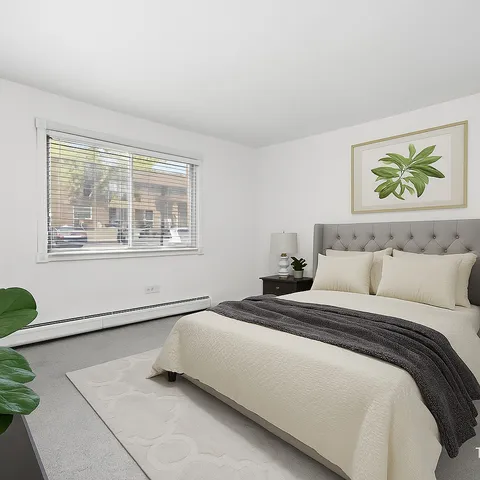 a bedroom with a bed and painting on the wall