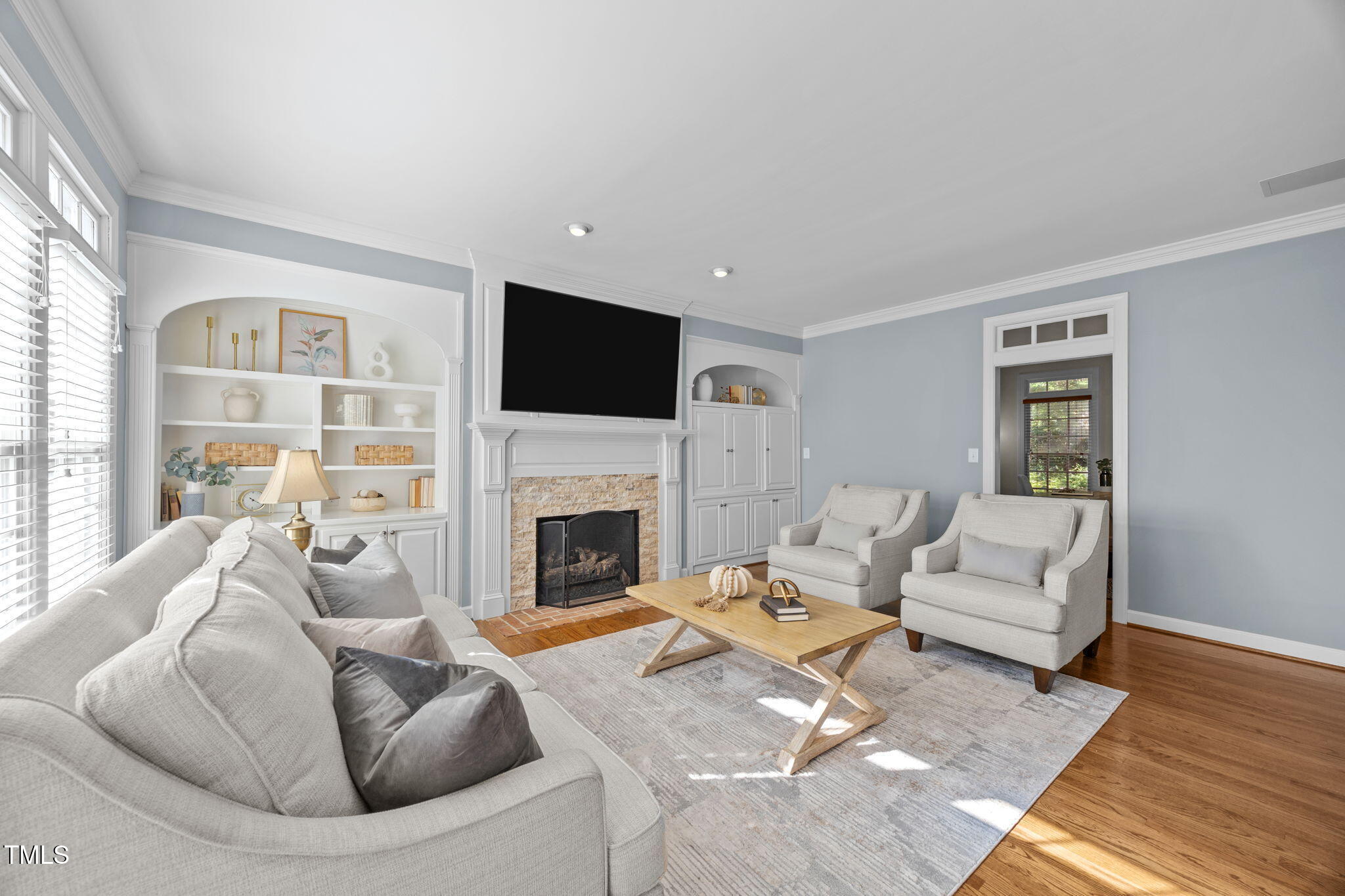 8001 Kukui Court Raleigh, NC 27613 - Photo 12 of 51 a living room with furniture fireplace and a flat screen tv