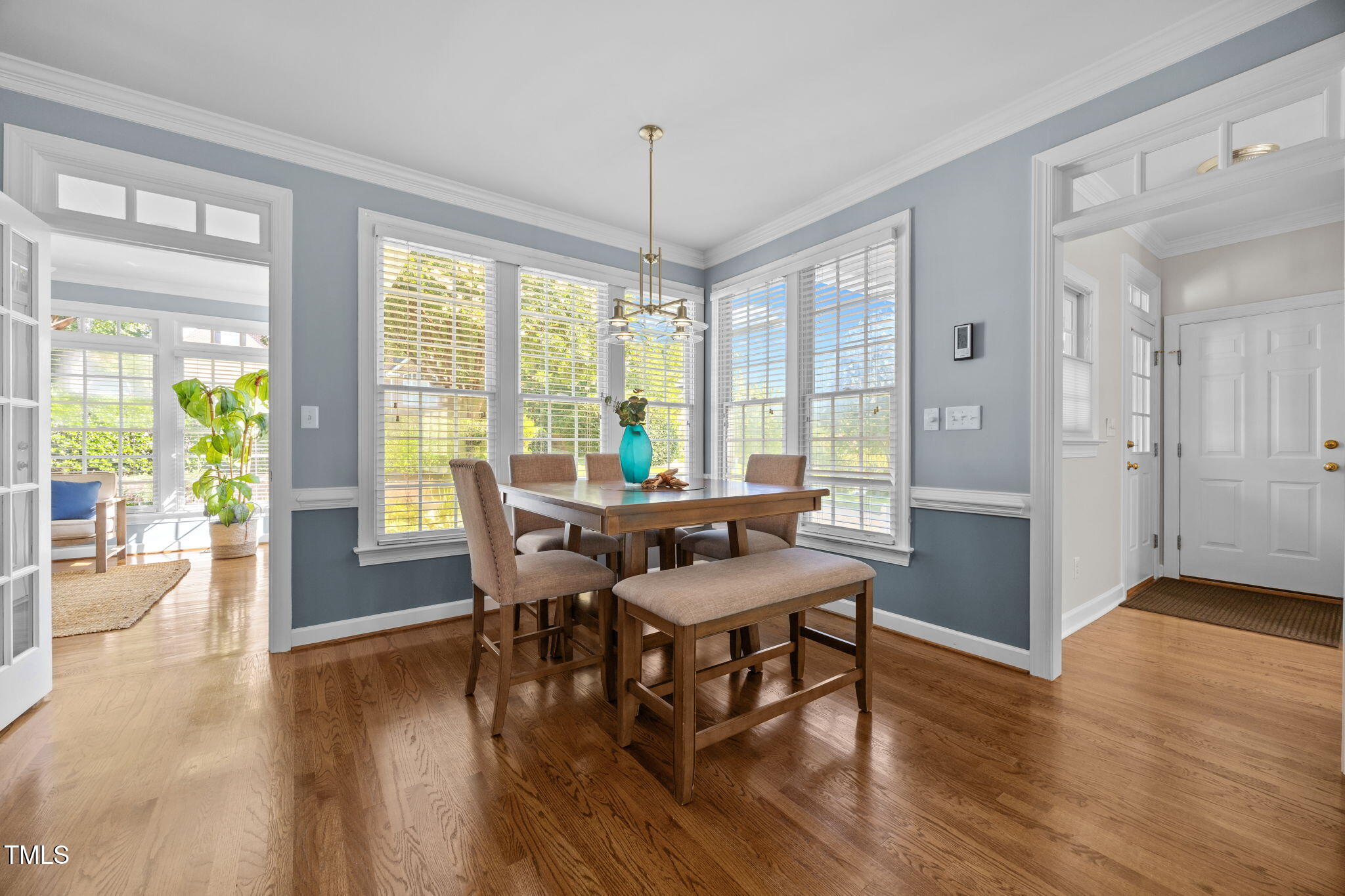 8001 Kukui Court Raleigh, NC 27613 - Photo 20 of 51 a view of a dining room with furniture window and wooden floor