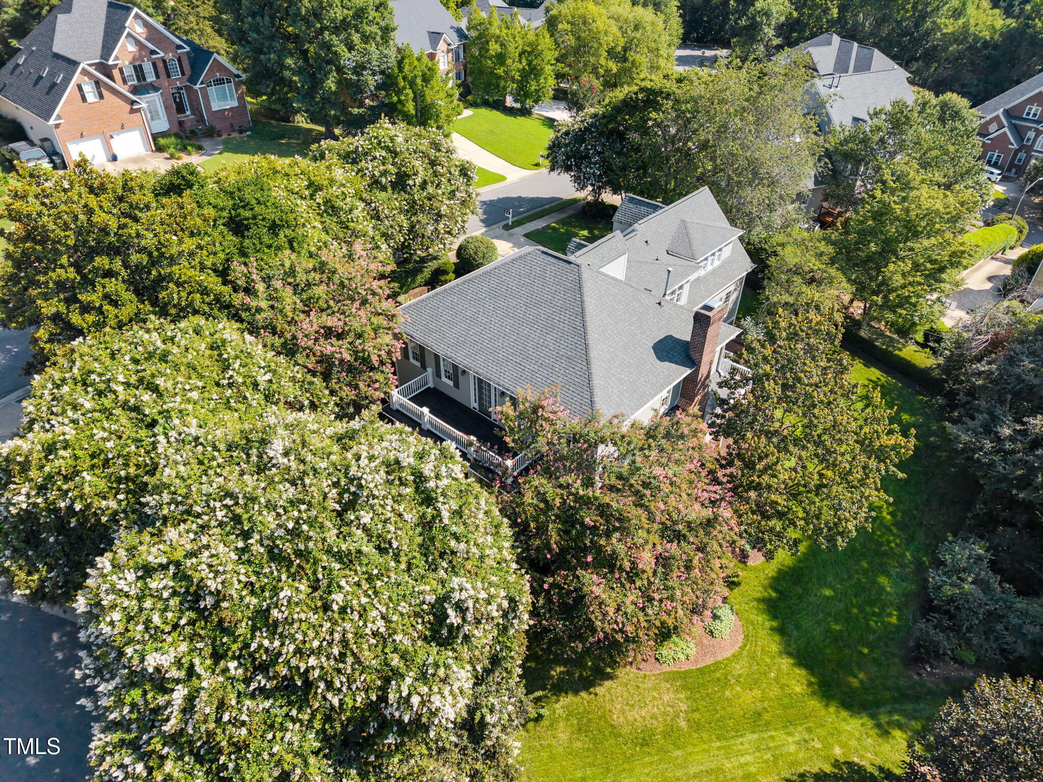 8001 Kukui Court Raleigh, NC 27613 - Photo 2 of 51 an aerial view of a house with a yard and garden