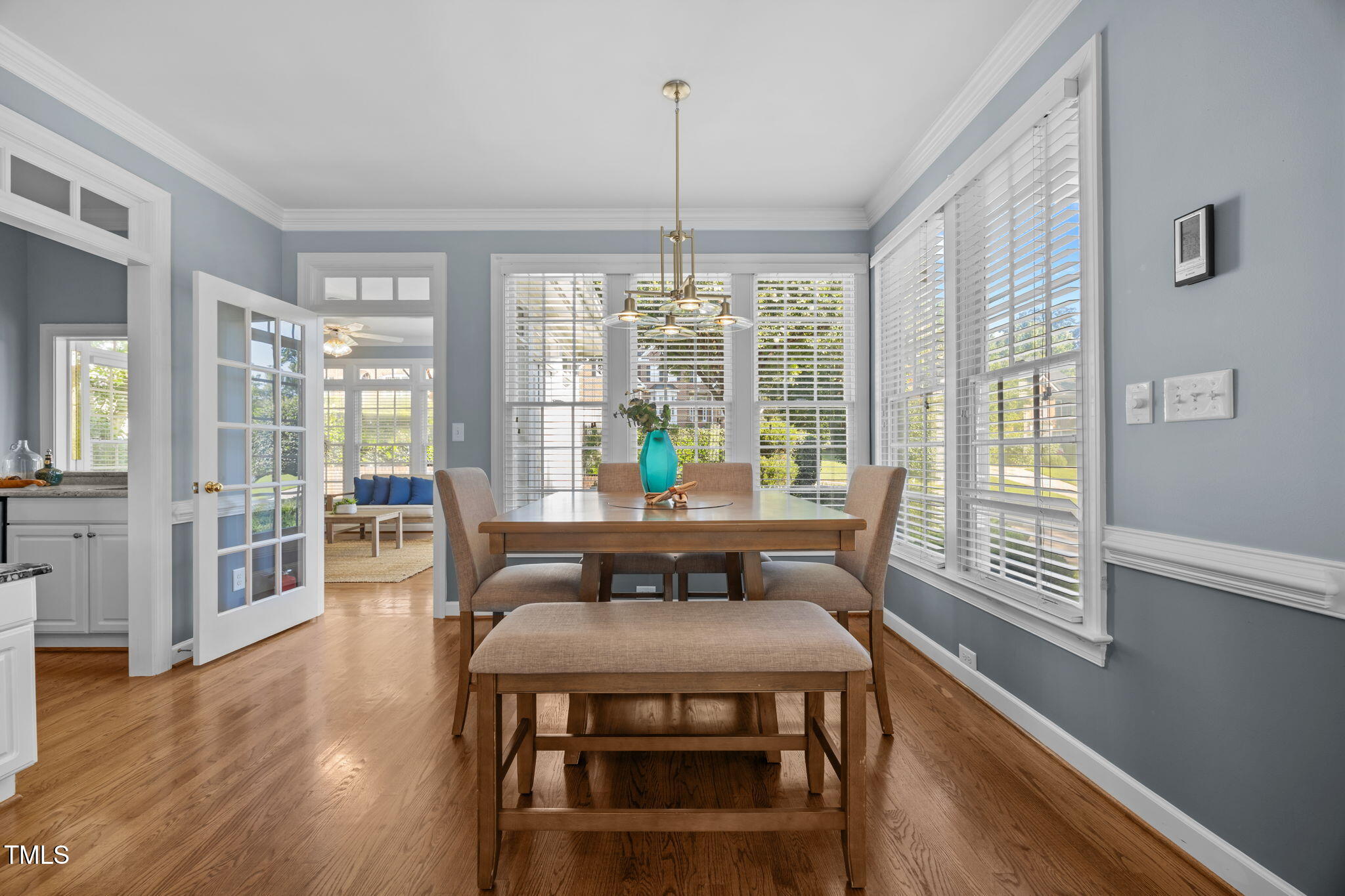 8001 Kukui Court Raleigh, NC 27613 - Photo 21 of 51 a view of a dining room with furniture wooden floor and a chandelier