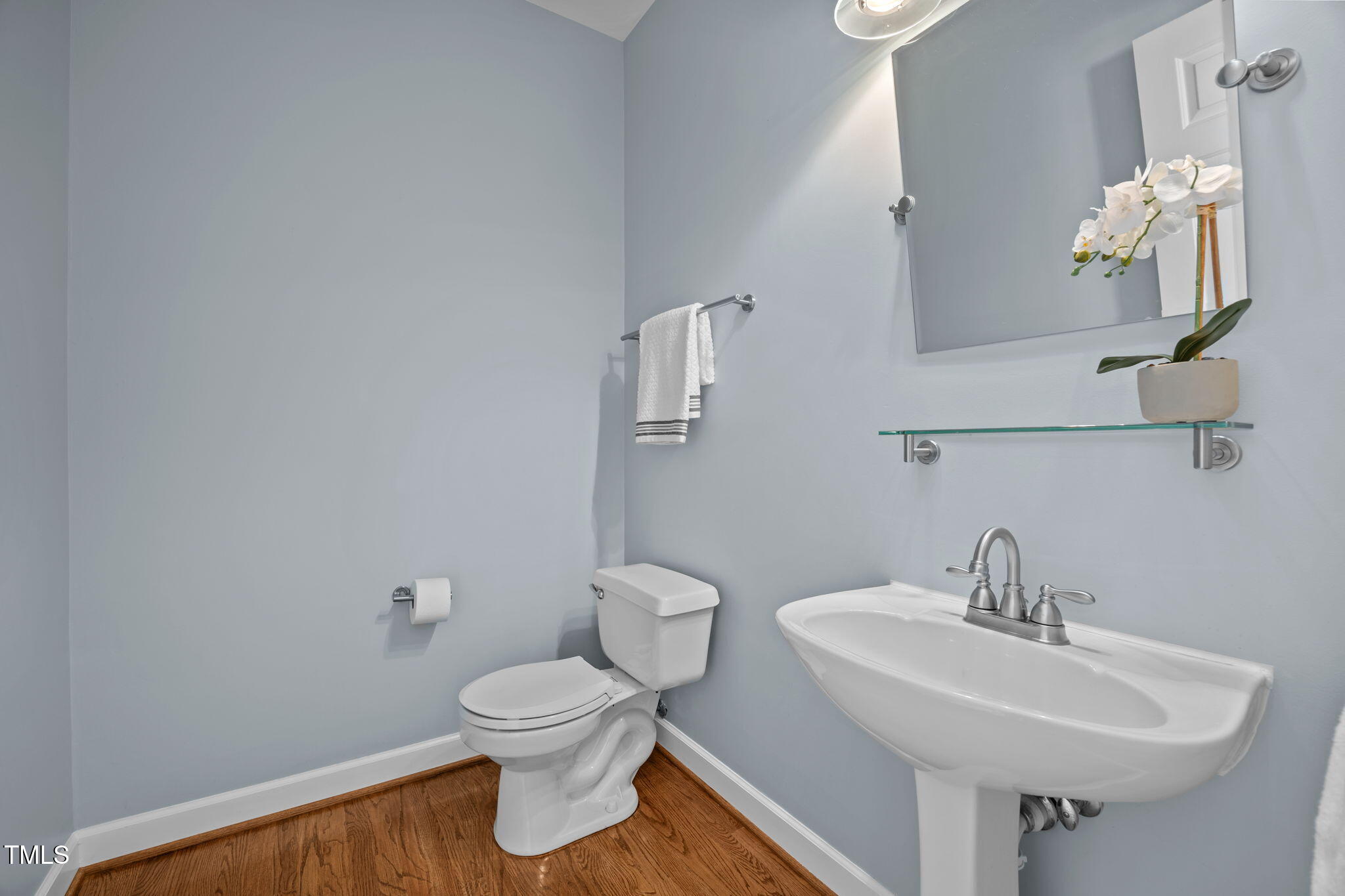 8001 Kukui Court Raleigh, NC 27613 - Photo 29 of 51 a bathroom with a toilet sink and mirror