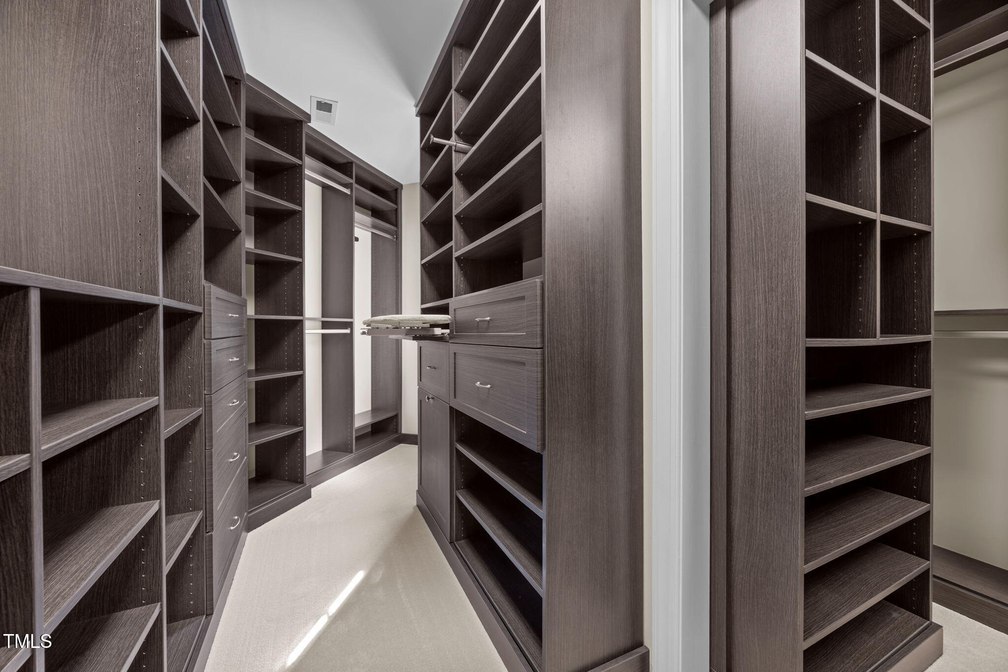 8001 Kukui Court Raleigh, NC 27613 - Photo 33 of 51 a view of walk in closet with empty racks