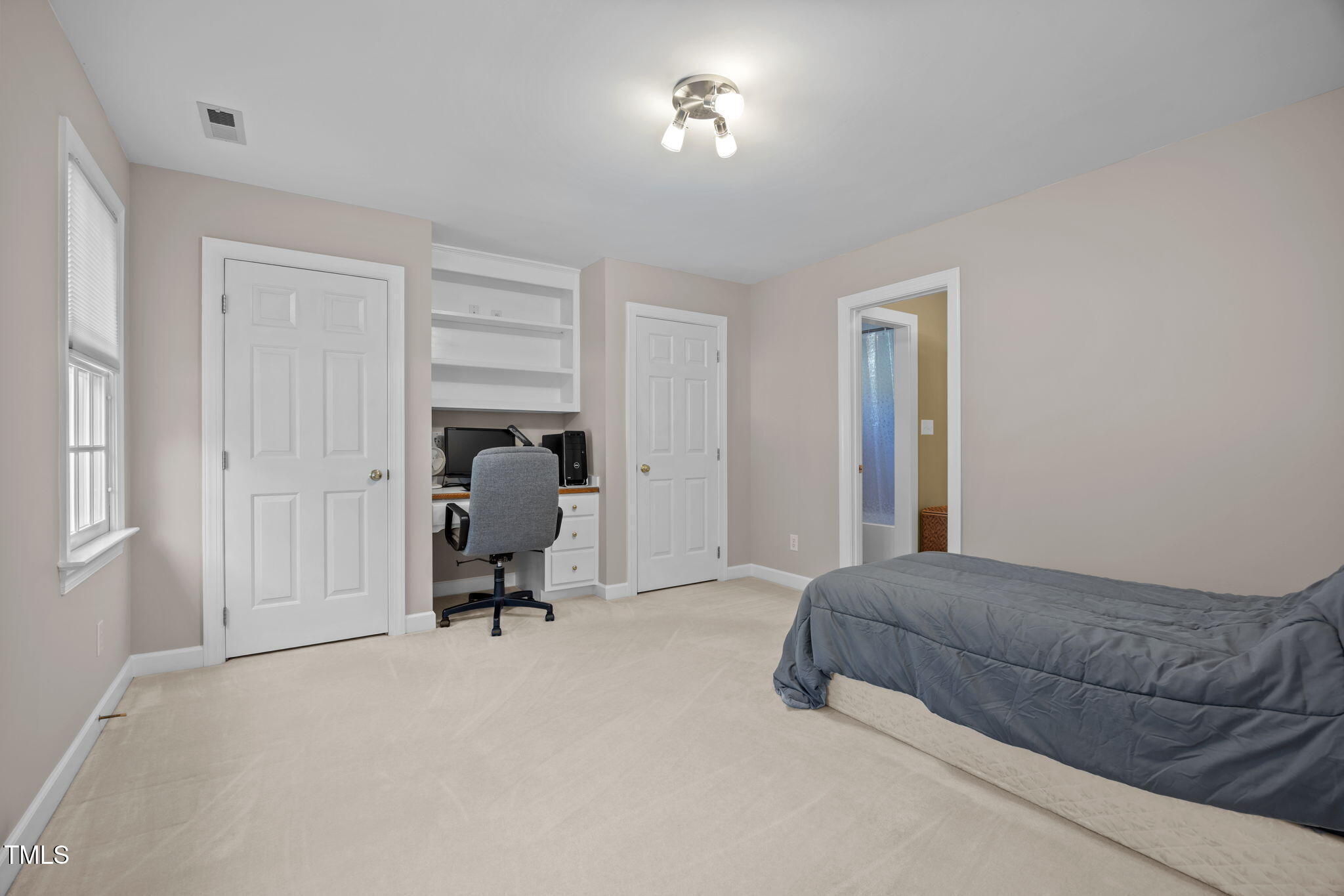 8001 Kukui Court Raleigh, NC 27613 - Photo 36 of 51 a bedroom with a bed and gym equipment