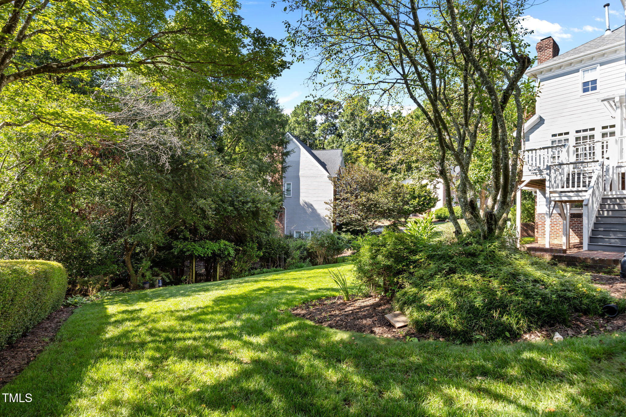 8001 Kukui Court Raleigh, NC 27613 - Photo 46 of 51 a backyard of a house with lots of green space