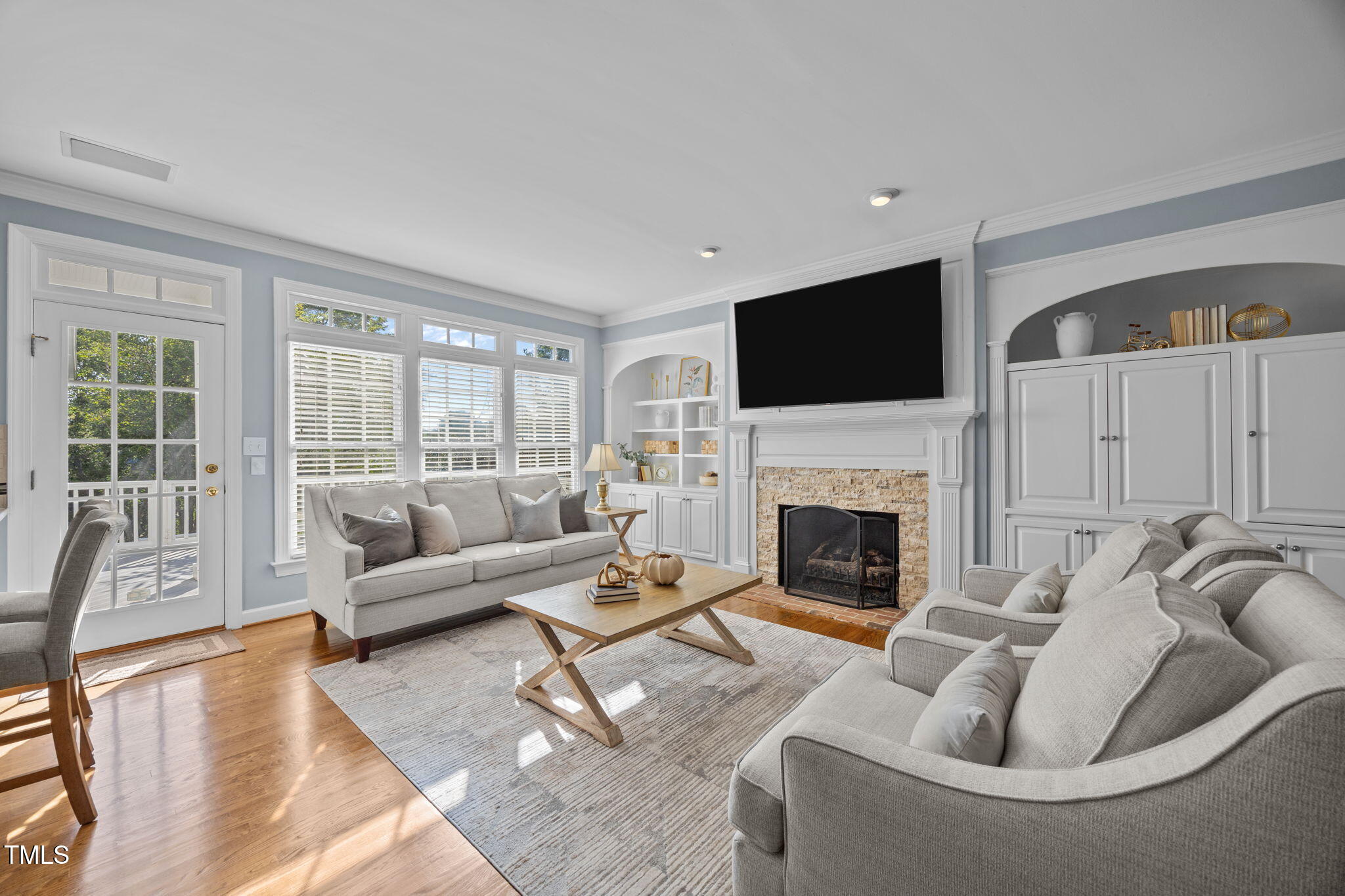 8001 Kukui Court Raleigh, NC 27613 - Photo 10 of 51 a living room with furniture a fireplace and a flat screen tv