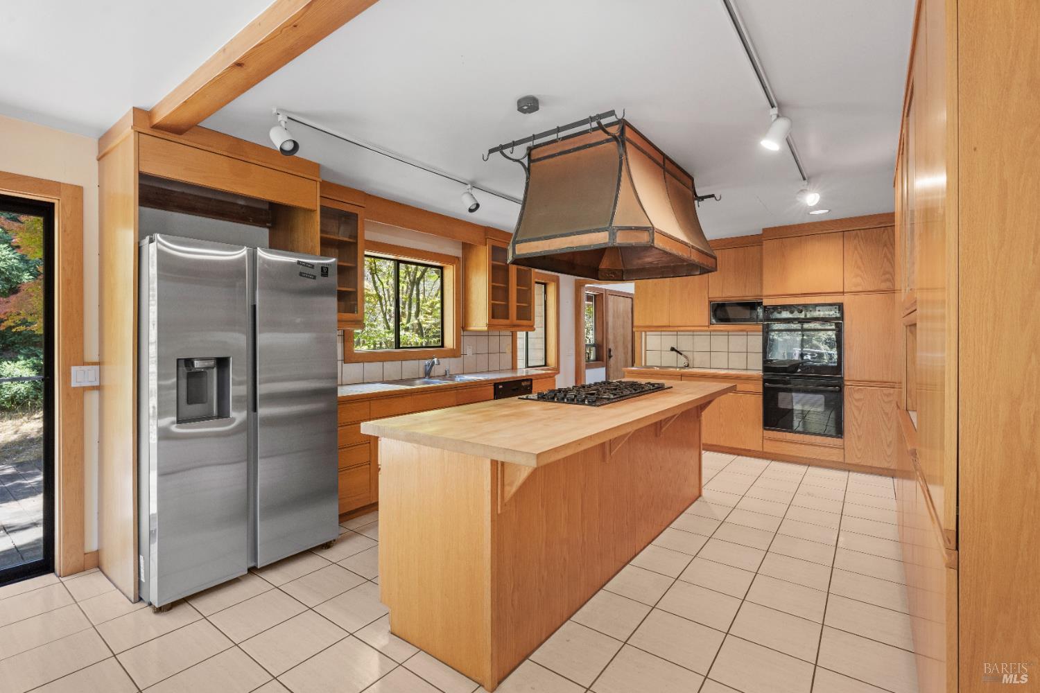 42795 Curley Lane Point Arena, CA 95468 - Photo 1 of 1 a large kitchen with stainless steel appliances kitchen island granite countertop a refrigerator and a stove